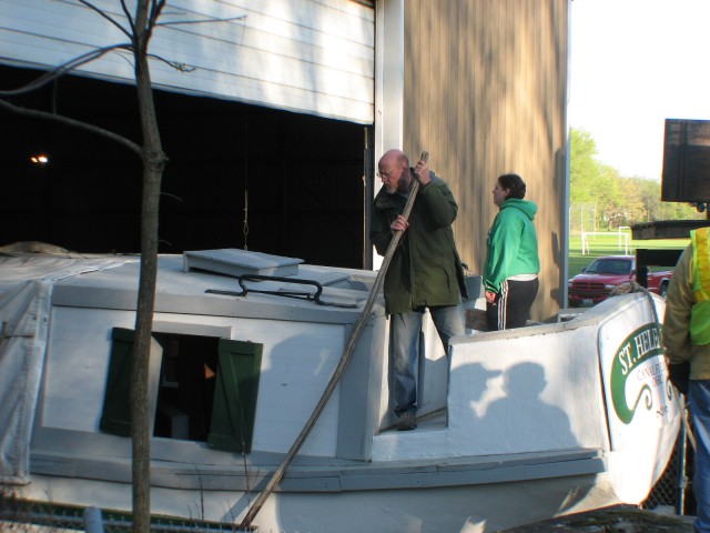 Boat Crew Carefully Steering the Boat Out of Dry Dock